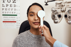 Eye doctor testing patient’s eyesight in optometrist's office